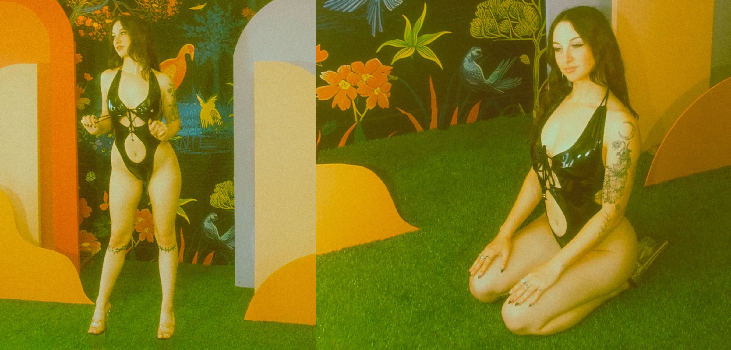 a heavily tattooed girl sitting on fake green grass wearing a black latex bodysuit